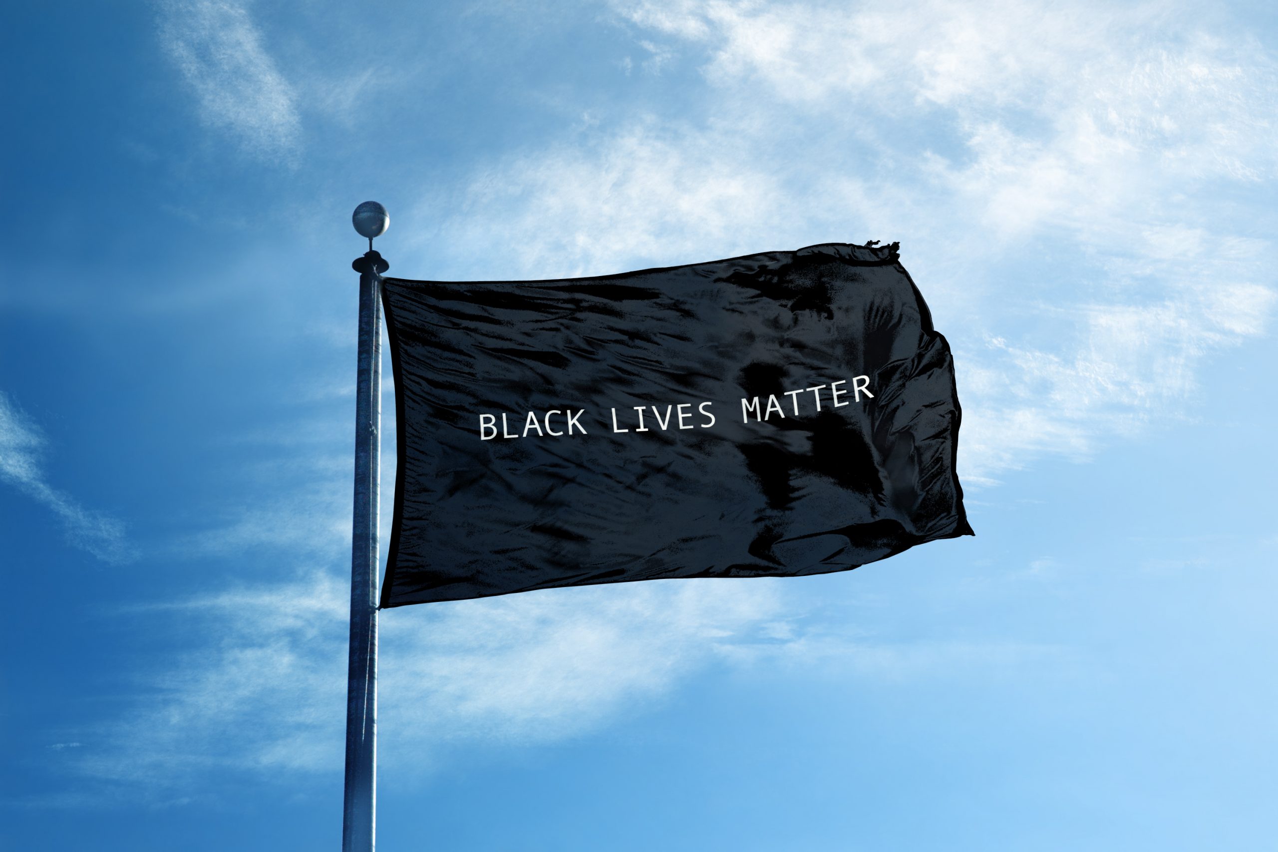 A black lives matter flag flies in the wind