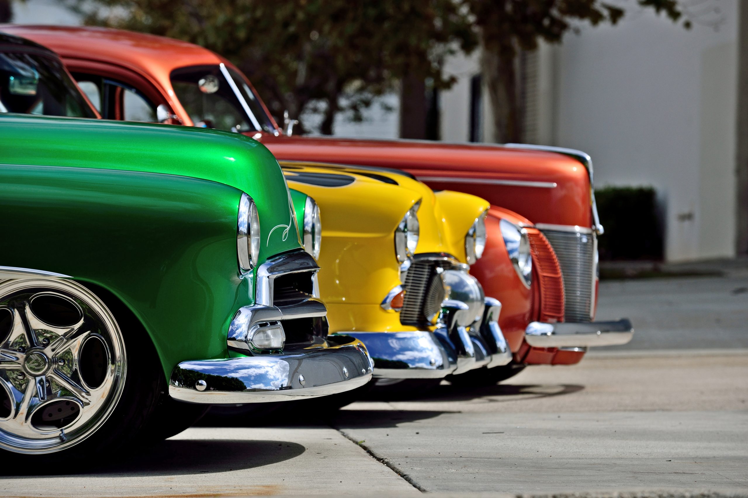 Classic cars lined up at a car show