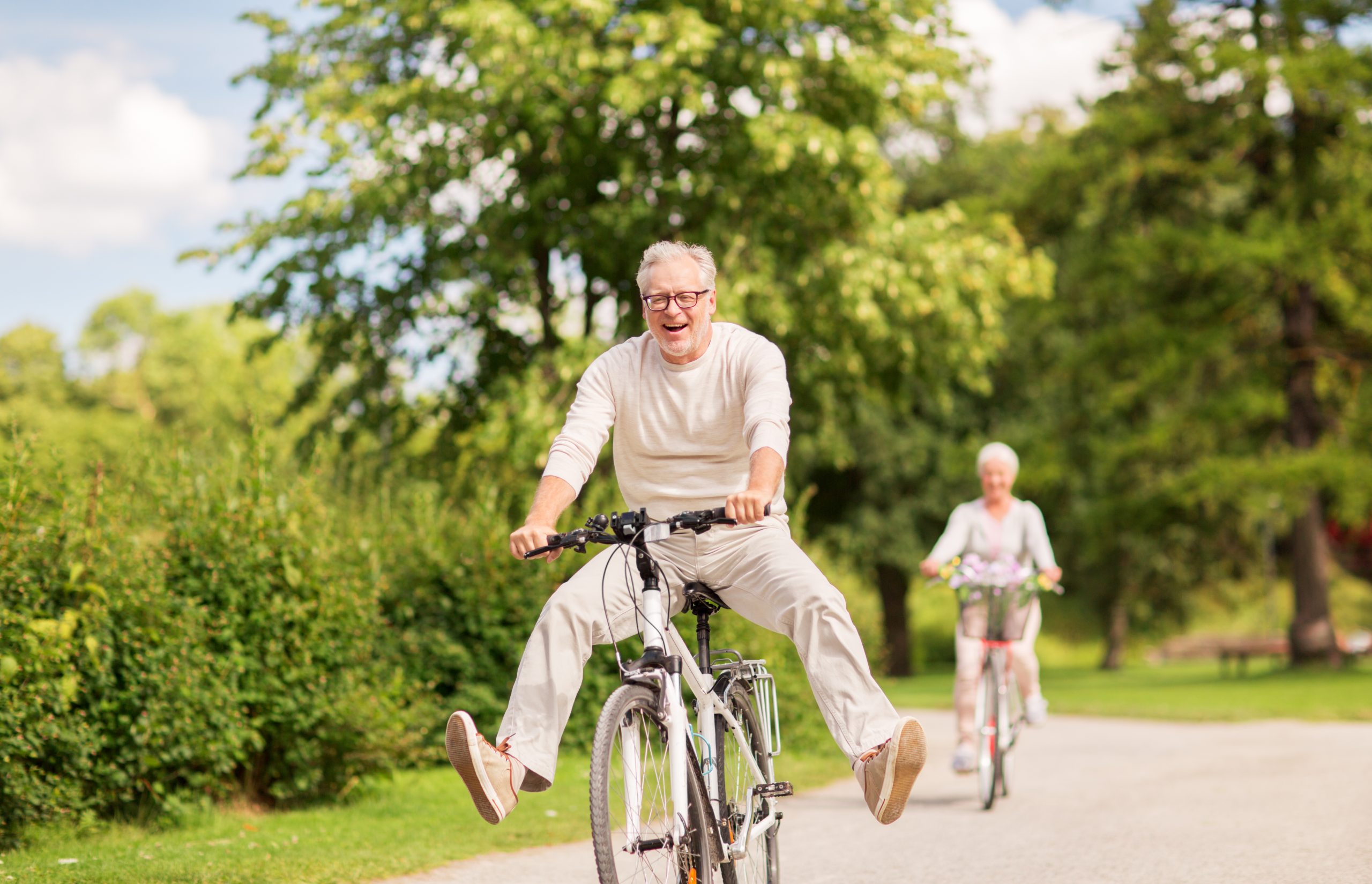 Adult man and woman having fun riding bikes