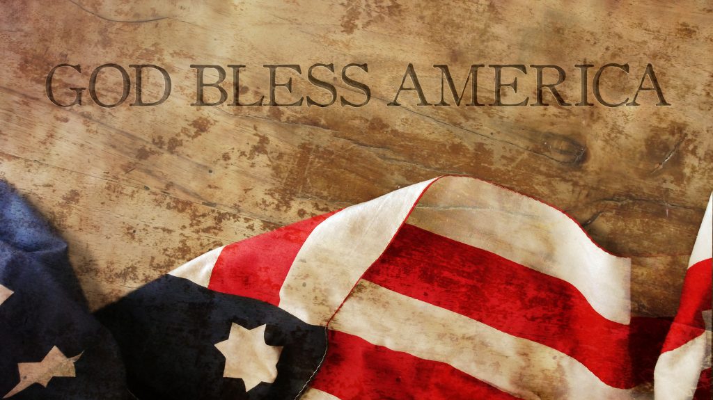 American flag on parchment that says God Bless America