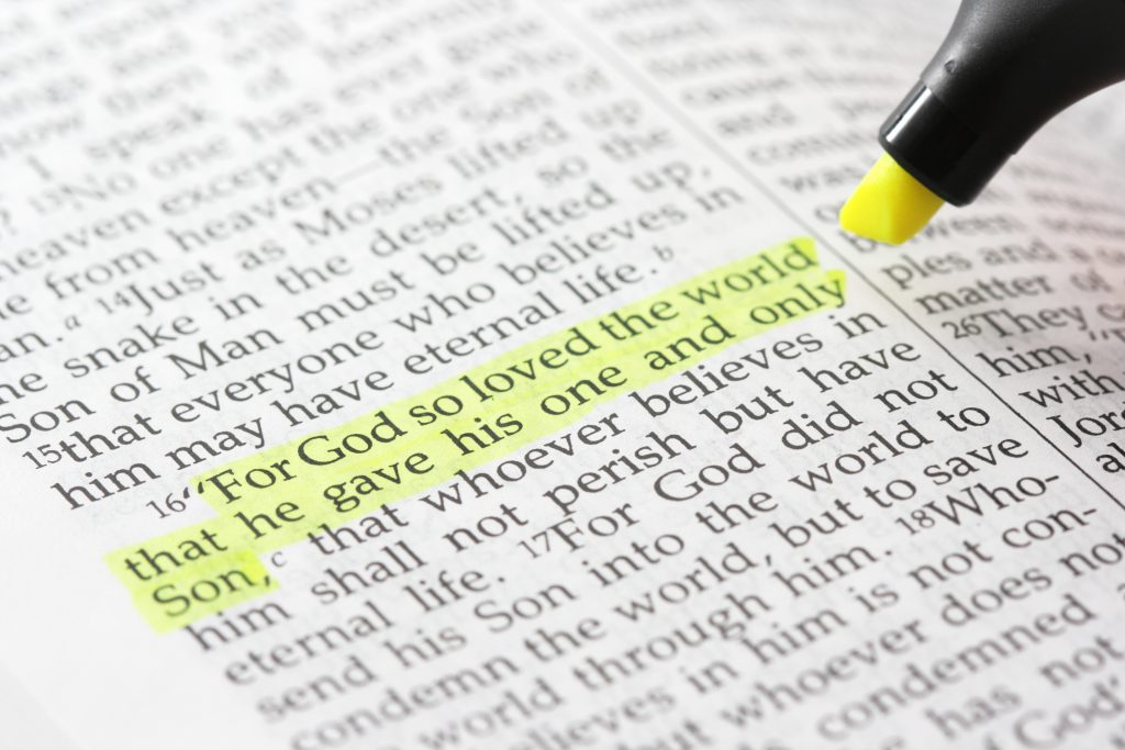 a highlighter goes over a section of bible verses.
