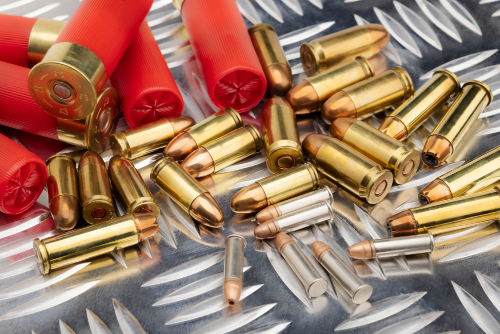 Several calibers of bullets in a pile on a table.