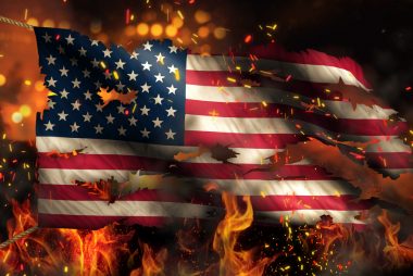 A burning American flag in flames set fire by people that hate America and love open borders.