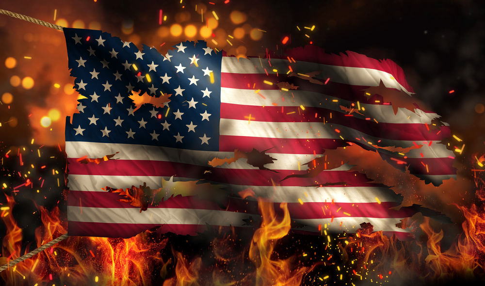 A burning American flag in flames set fire by people that hate America and love open borders.