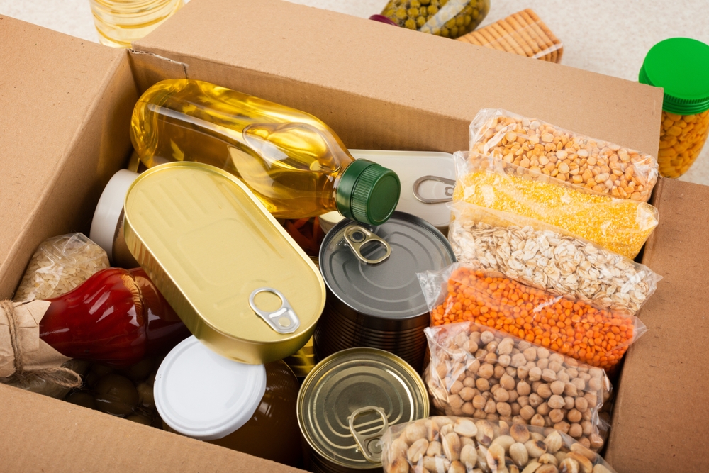 Dried and canned food in a box used for prepping in case of emergency.